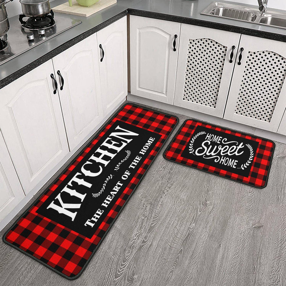 Two kitchen mats with text on a wooden floor in a kitchen setting.