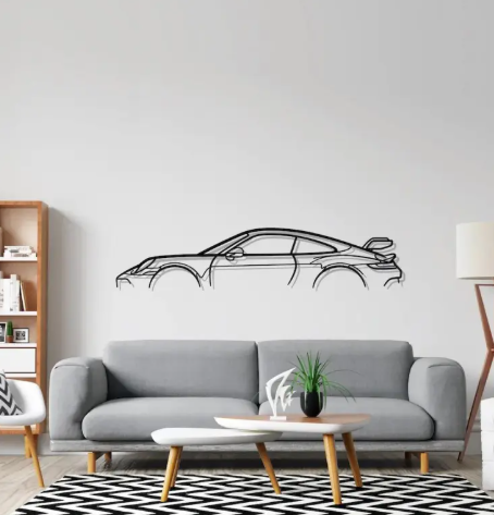 Living room with a gray sofa, coffee table, and car-shaped wall decal.