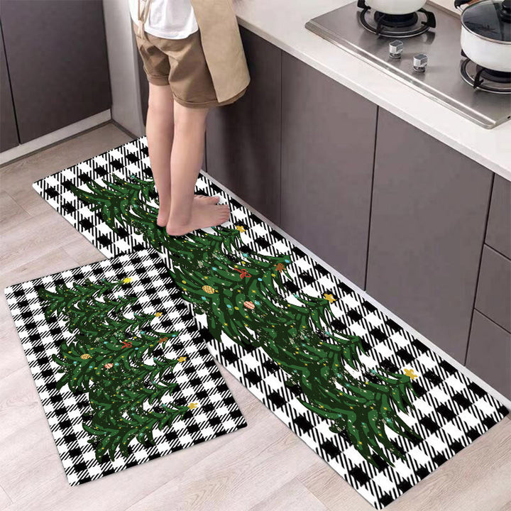 Person stepping onto a kitchen mat with Christmas tree design in a modern kitchen.