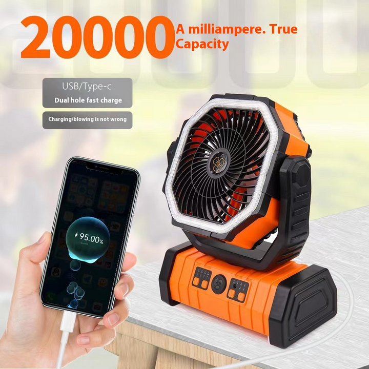 Orange and black portable fan with phone charging feature on a blurred background
