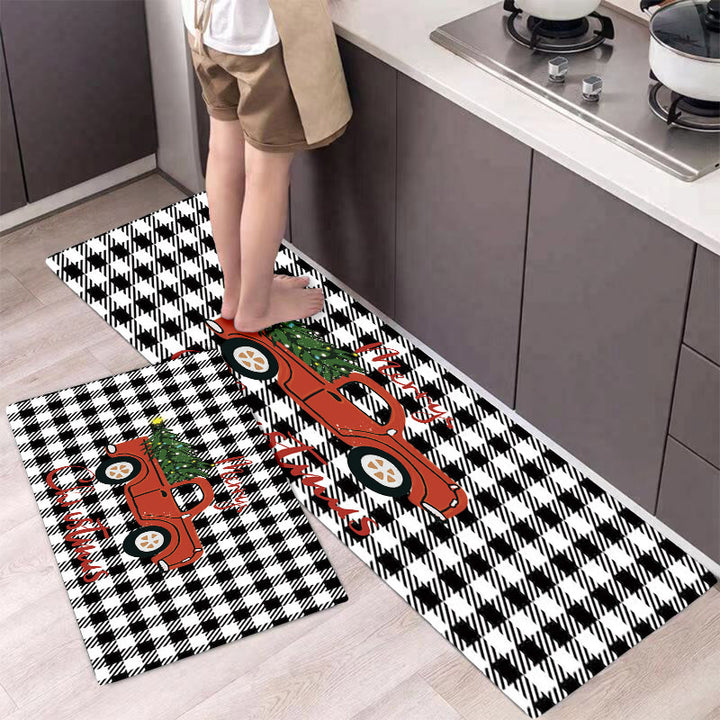 Two decorative kitchen mats with red truck designs on a checkered pattern, placed on a floor.