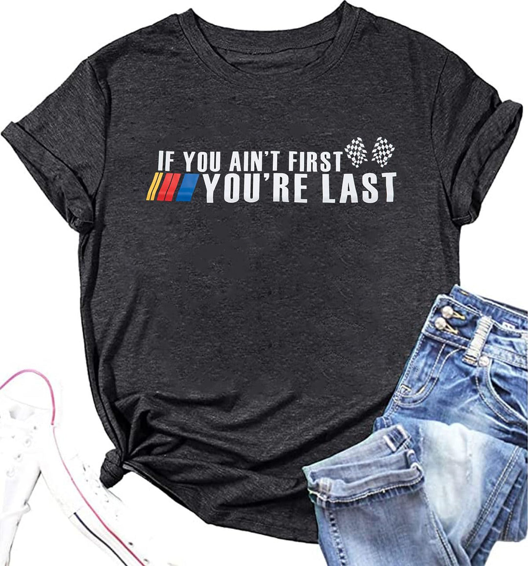 Black t-shirt with humorous text design and blue jeans on a white background