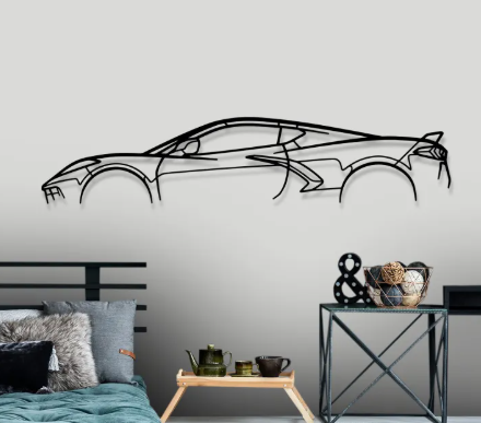 Car-shaped wall decal on a gray wall with a bed and table in the foreground.