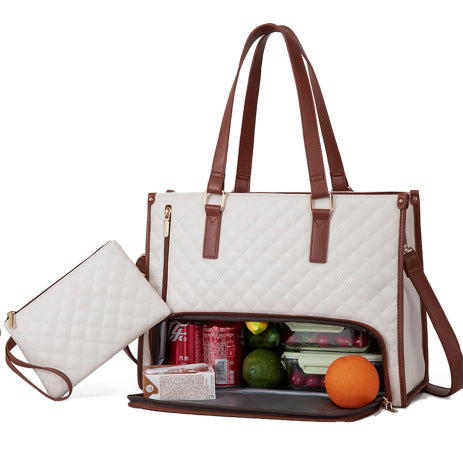 White diaper bag with brown straps containing snacks and fruits on a white background